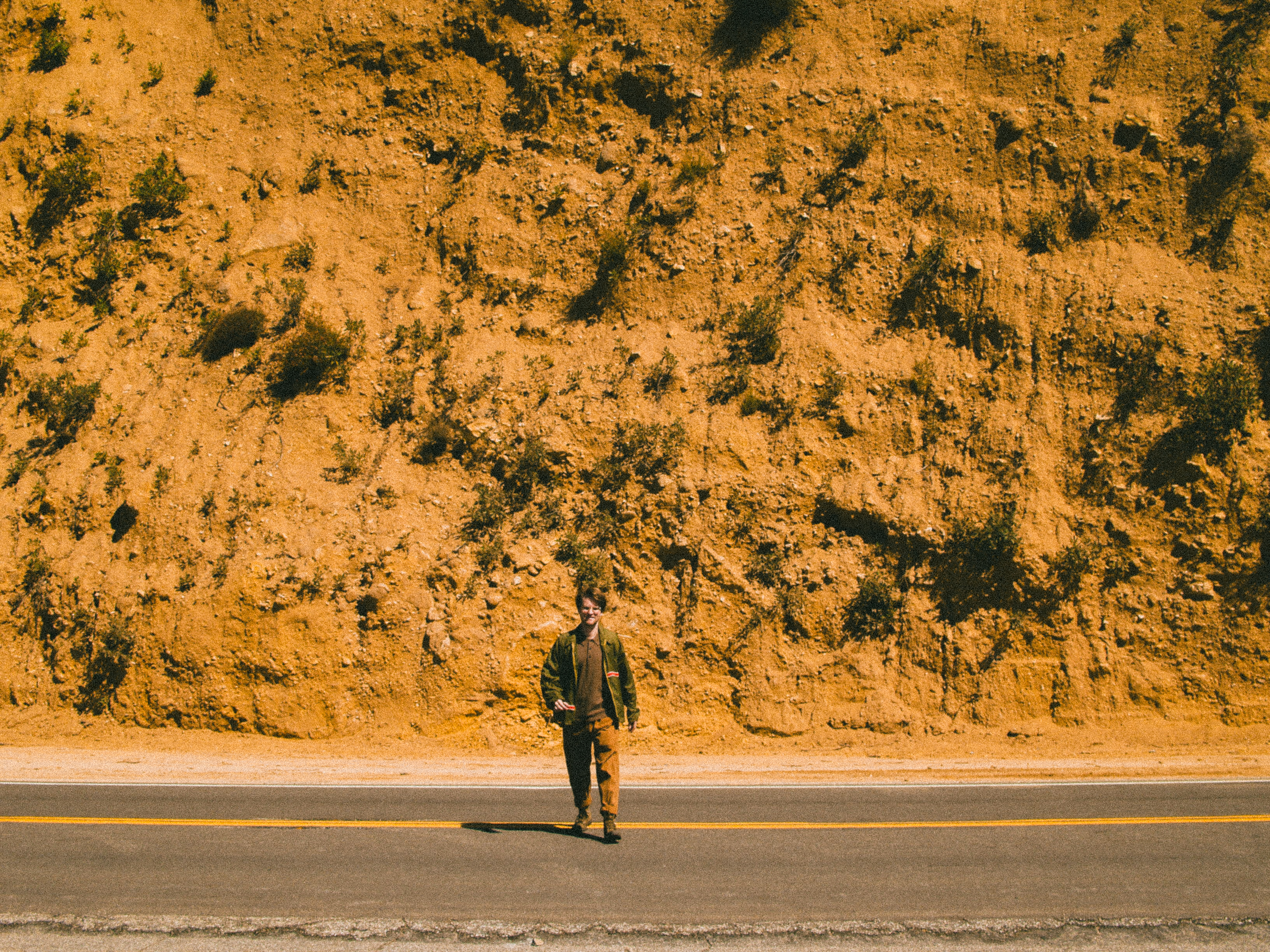 Atticus standing by a desert road